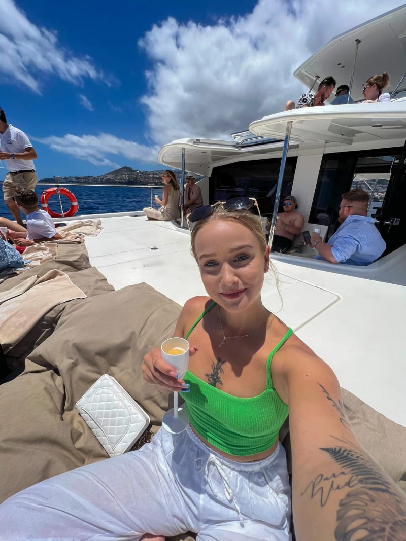 People on the front of a catamaran off the coast of Funchal, Madeira Island