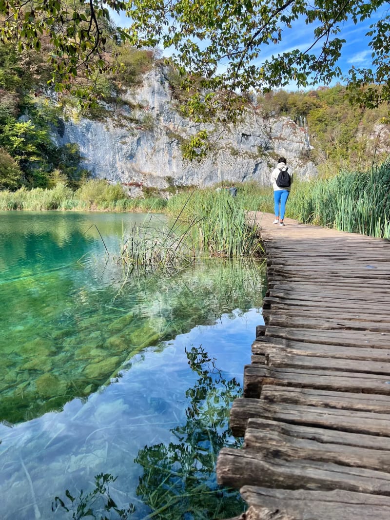 Wooden boardwalk hiking trail over a lake in Plitvice Lakes National Park, Croatia