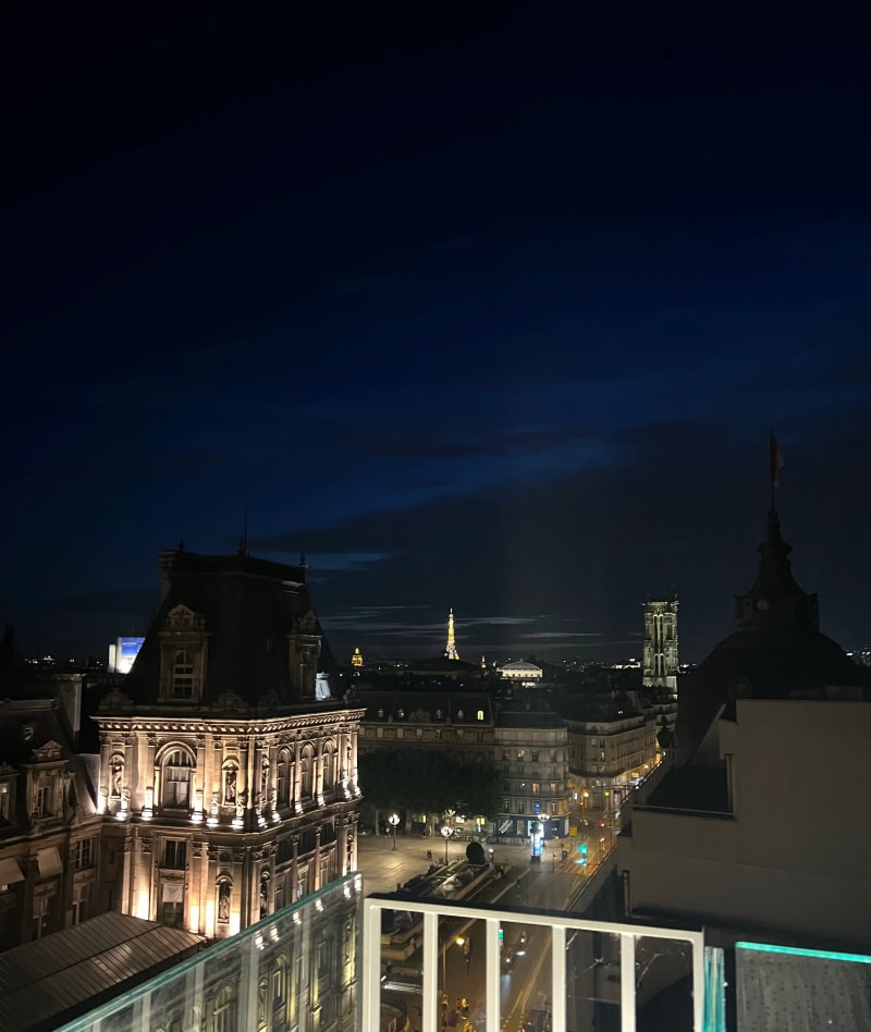 The Eiffel Tower at night from a rooftop in Paris, France