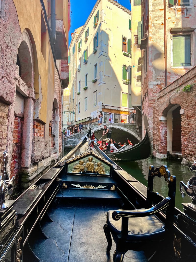 A gondola gliding down a narrow canal in Venice, Italy