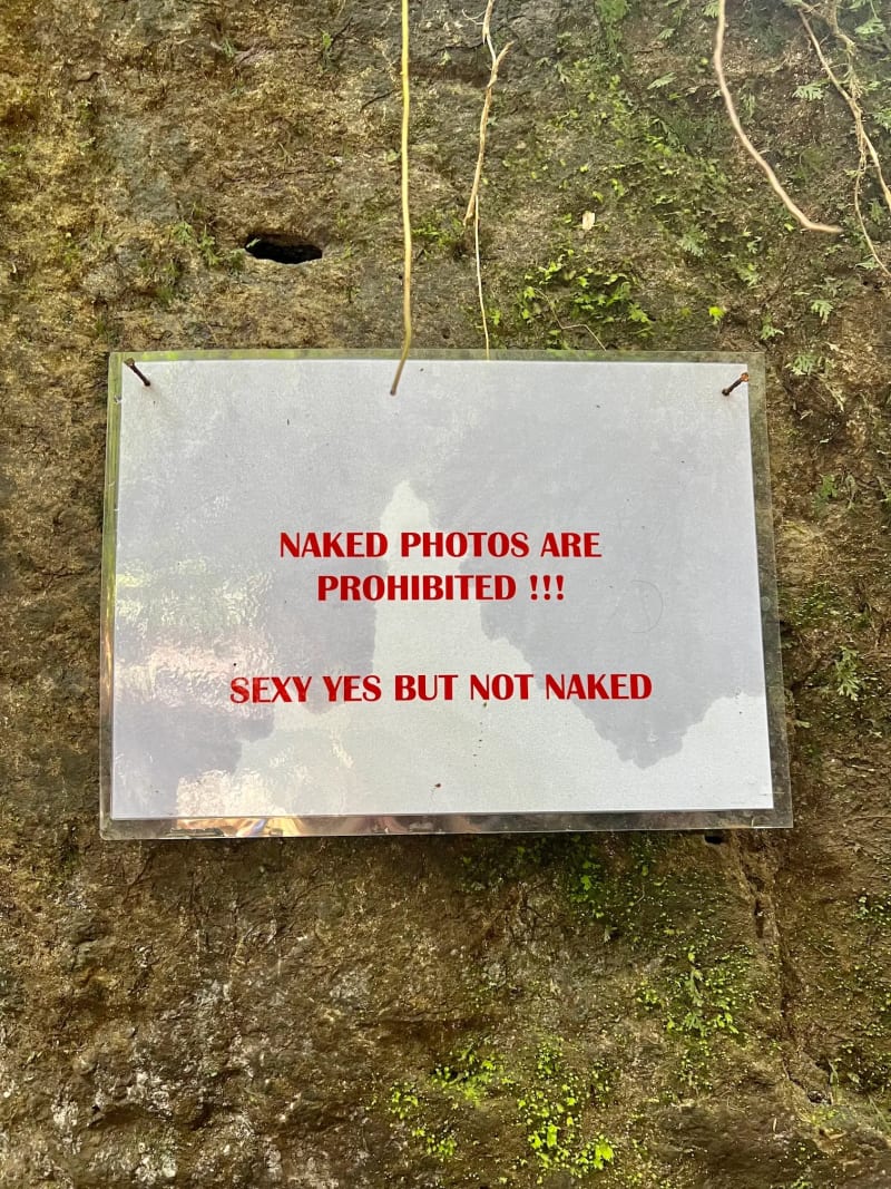 Funny sign at the Kanto Lampo Waterfall in Ubud, Bali, Indonesia
