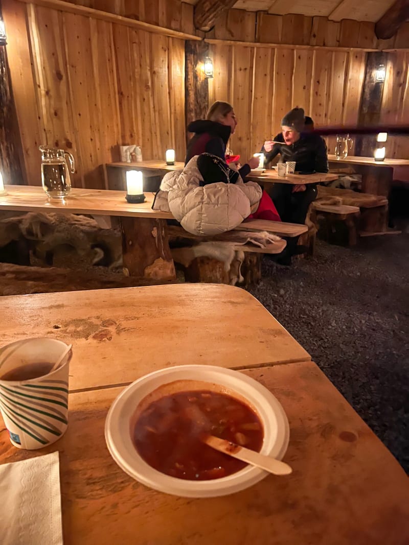 Reindeer stew inside of a traditional lavvo Sami tent in Tromsø, Norway in the winter