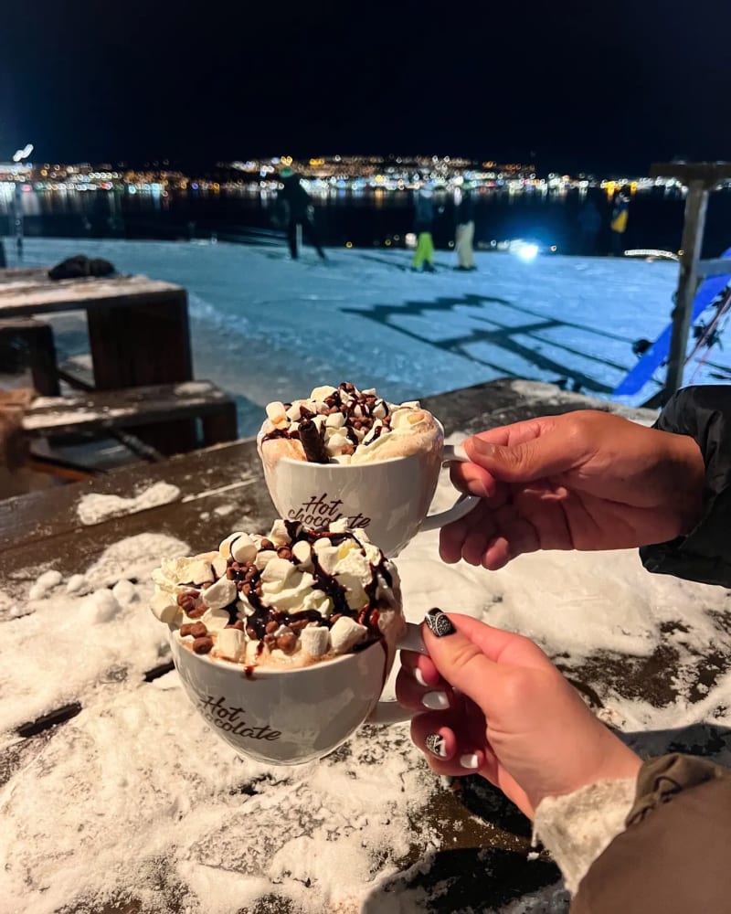 Delicious hot chocolate in Tromsø Norway in the winter with distant city views