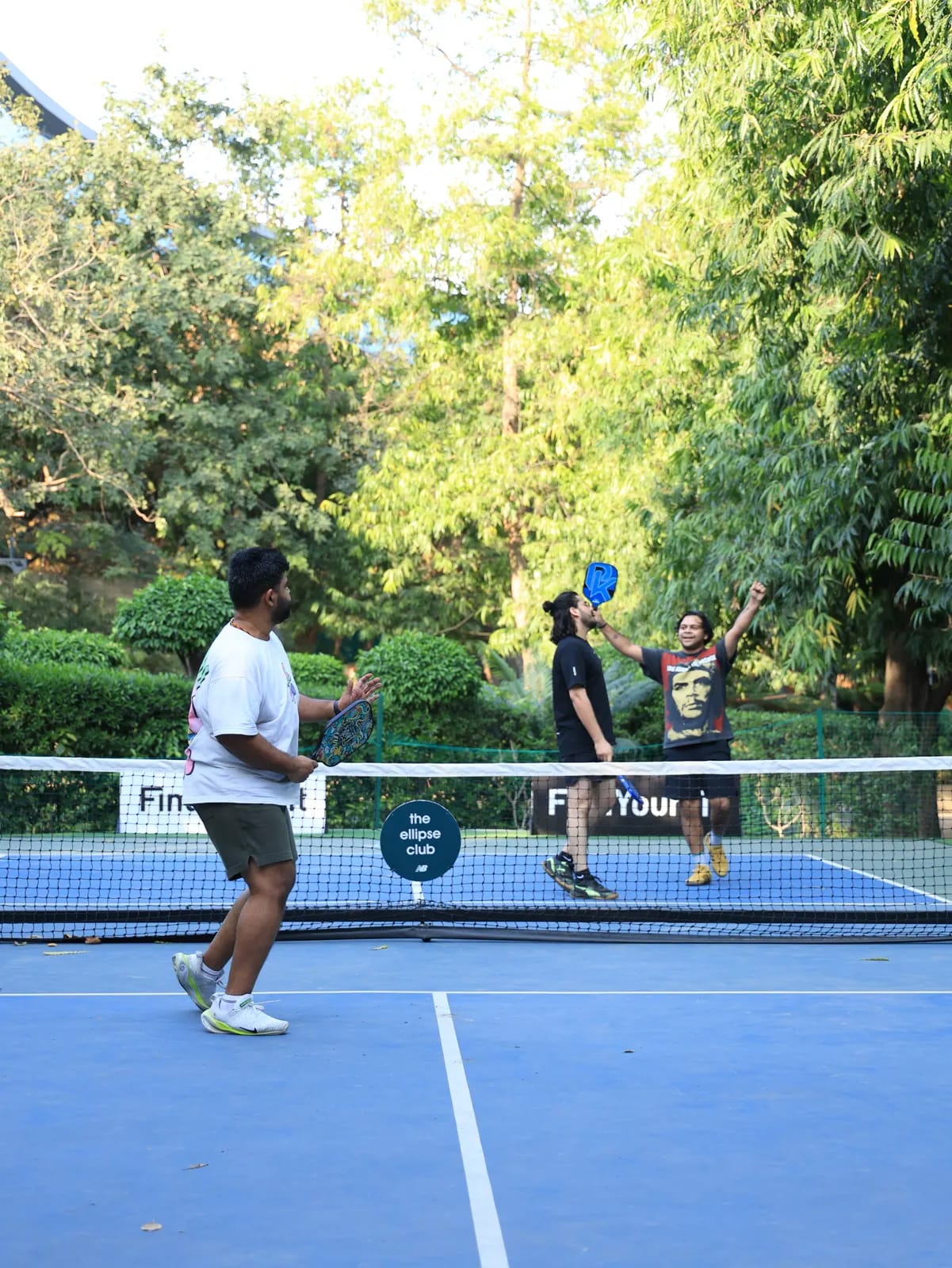 Players rallying on an outdoor court at a FindYourFit event