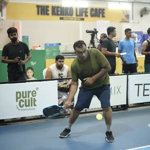 Indoor pickleball action at a FindYourFit tournament