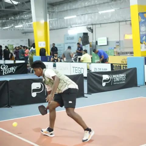 Indoor pickleball action at a FindYourFit tournament