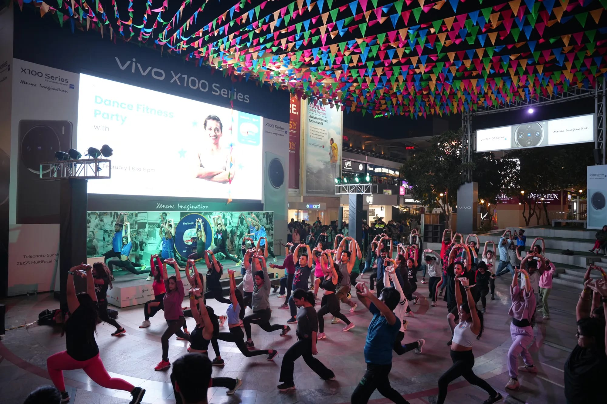 A dance fitness session under lights at The Wellness Carnival