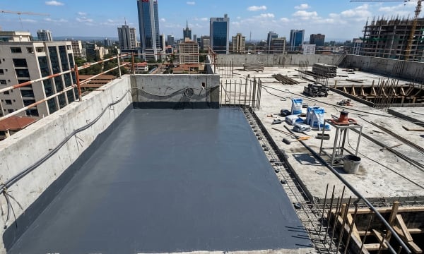 Concrete flat roof waterproofing membrane and parapet wall water sealant application