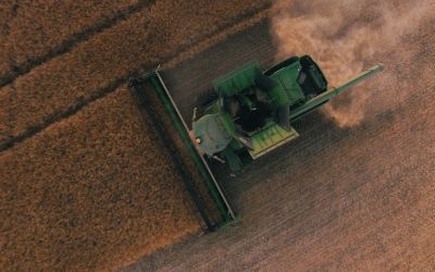 Aerial photo of a tractor plowing a field. Photo by Scott Goodwill on Unsplash