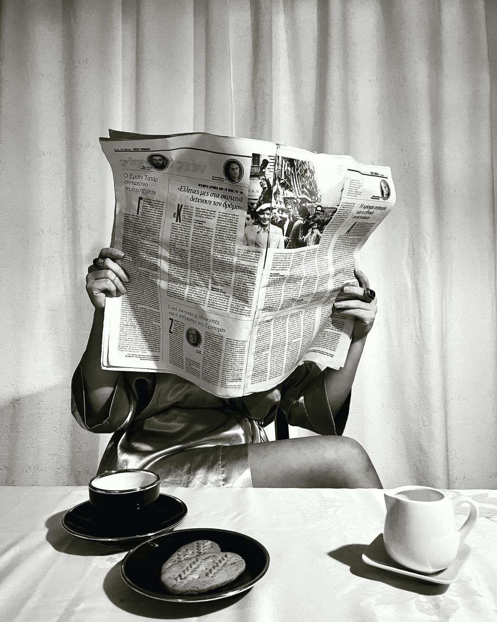 Photo of a woman reading a newspaper