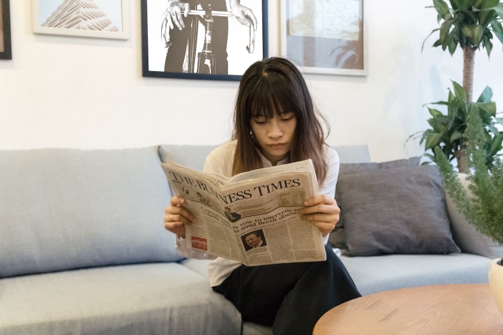 Photo of a man reading a newspaper