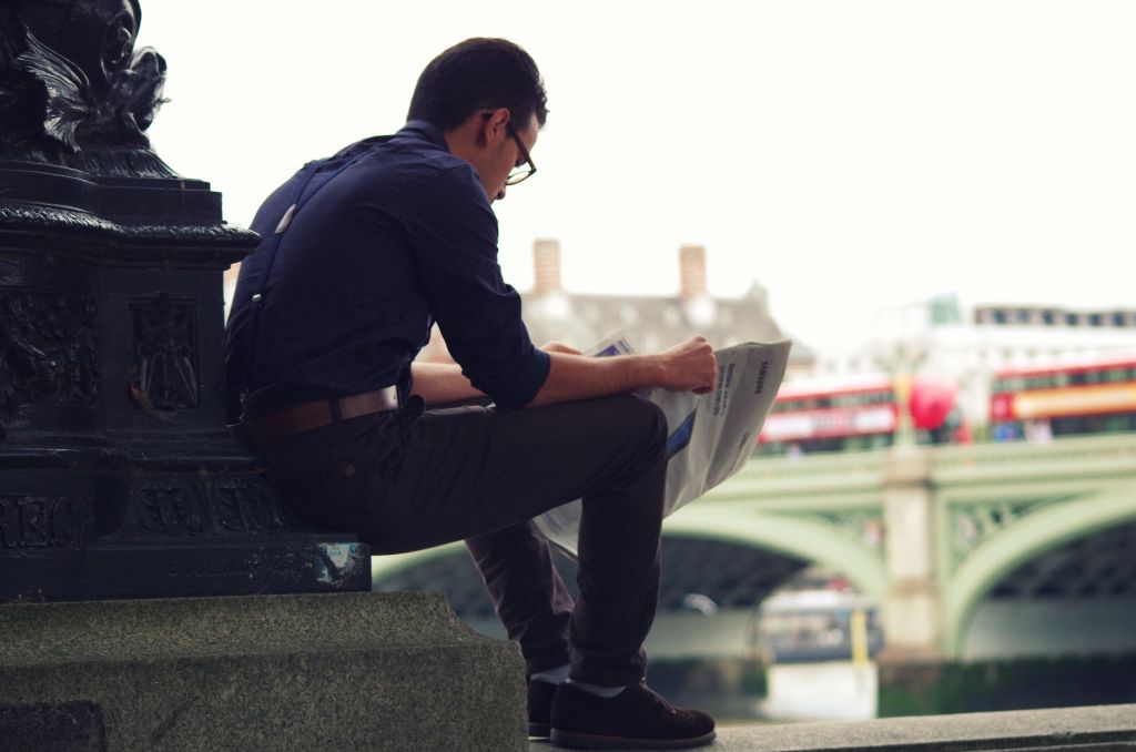 Photo of a man reading a newspaper