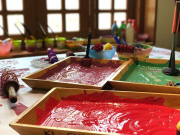 Bowls of colored paint on a table