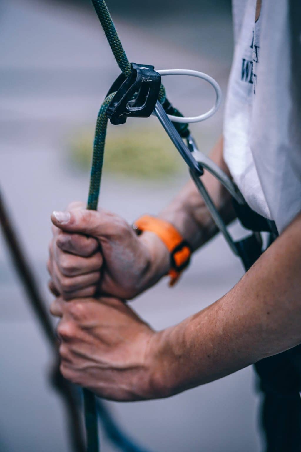 picture of someone adjusting a rock climbing safety harness