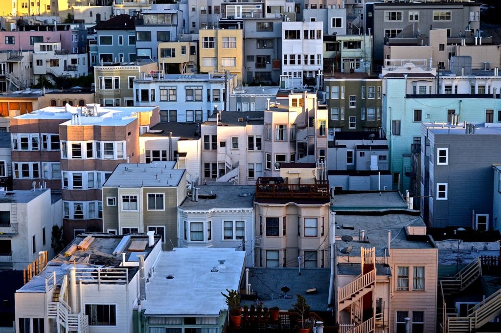 photo of san francisco neighborhood showing lots of multi-family apartment building, homes, and commercial buildings