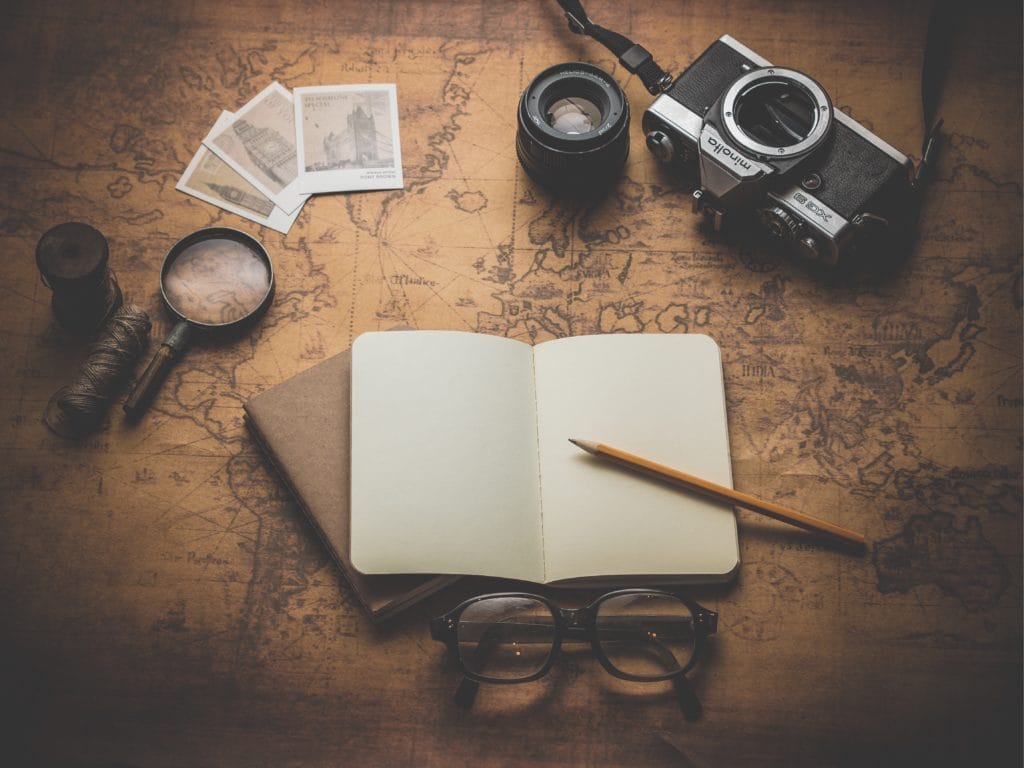 desk with maps, magnifying glasses, and other exploration metaphors