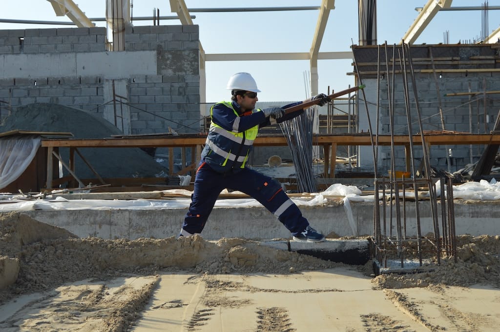 Photo of a construction worker welding some beams on a building to symbolize opportunity zone investing like the kind the EquityMultiple offers