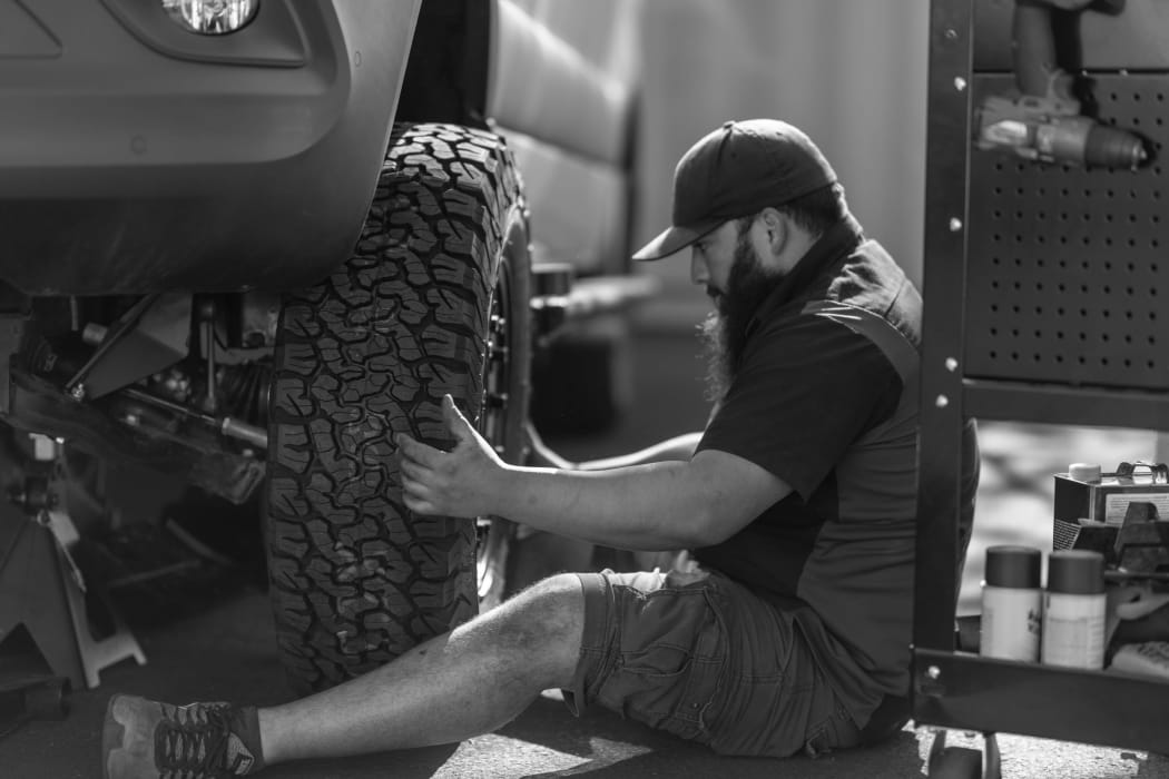 Upfitting technician installing wheels and tires