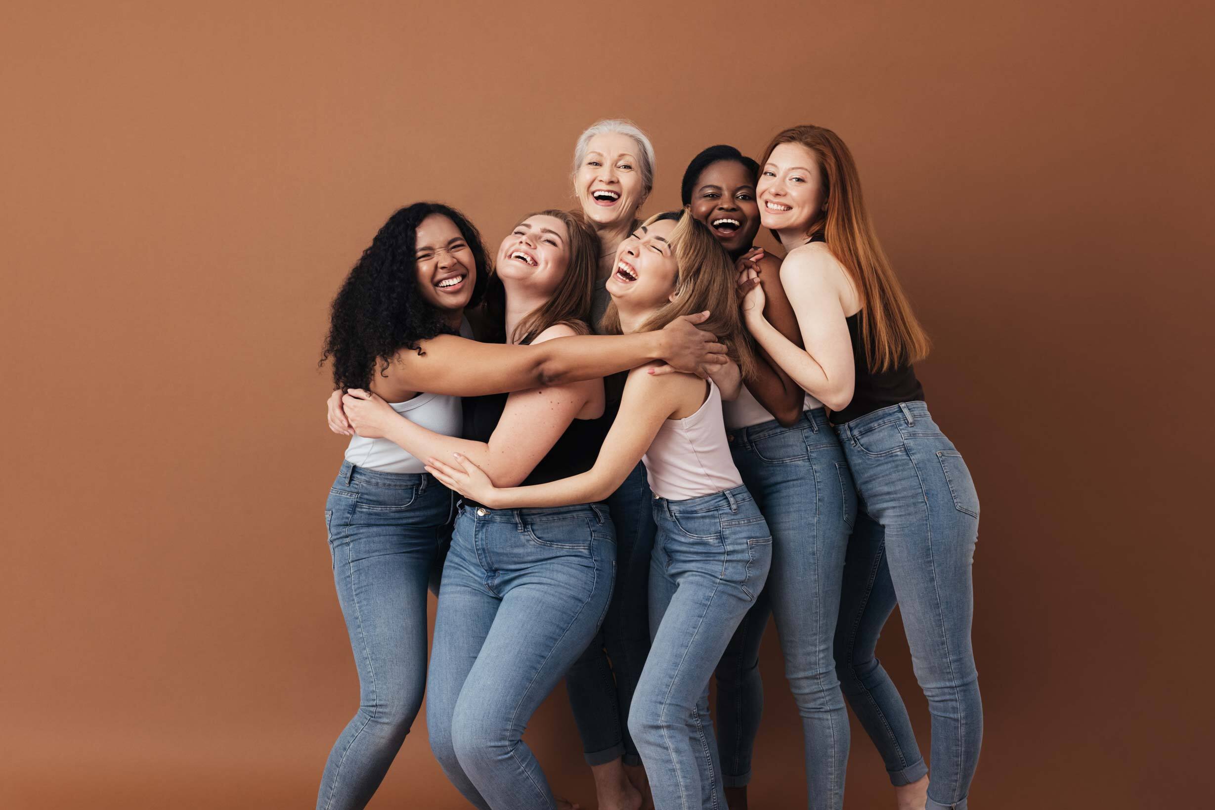 groupe de femmes de tout âge et de différentes origines qui s'enlacent