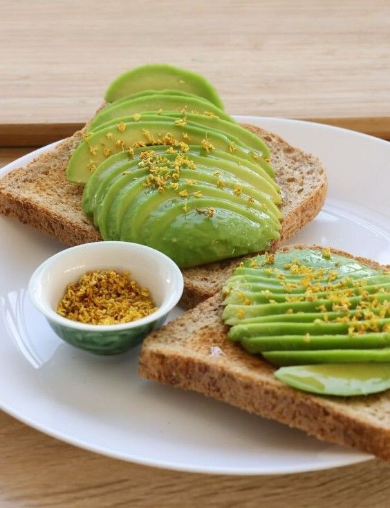 Avocado toast garni de fleurs d'osmanthus, mise en scène naturelle