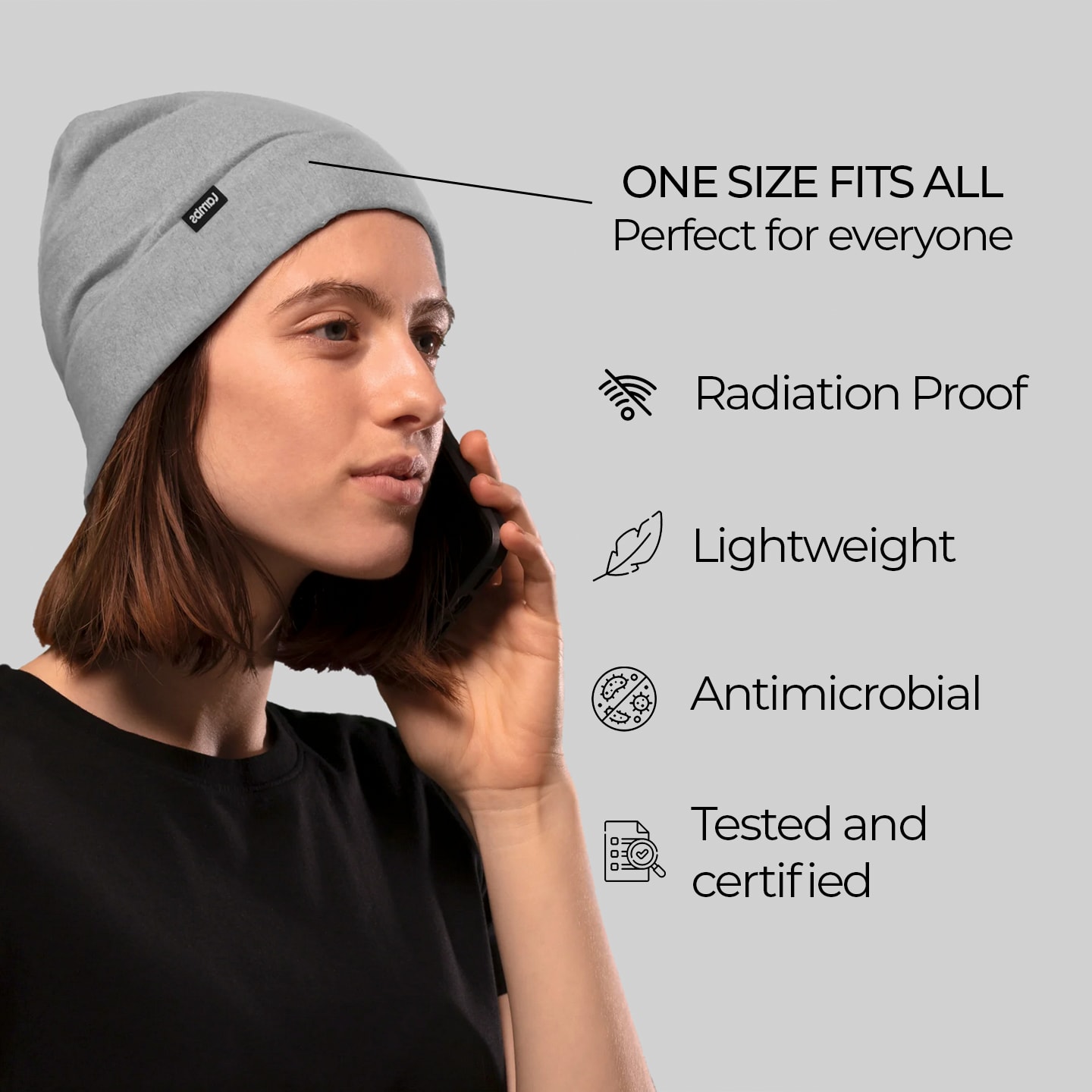 a woman wearing a beanie talking on a cell phone