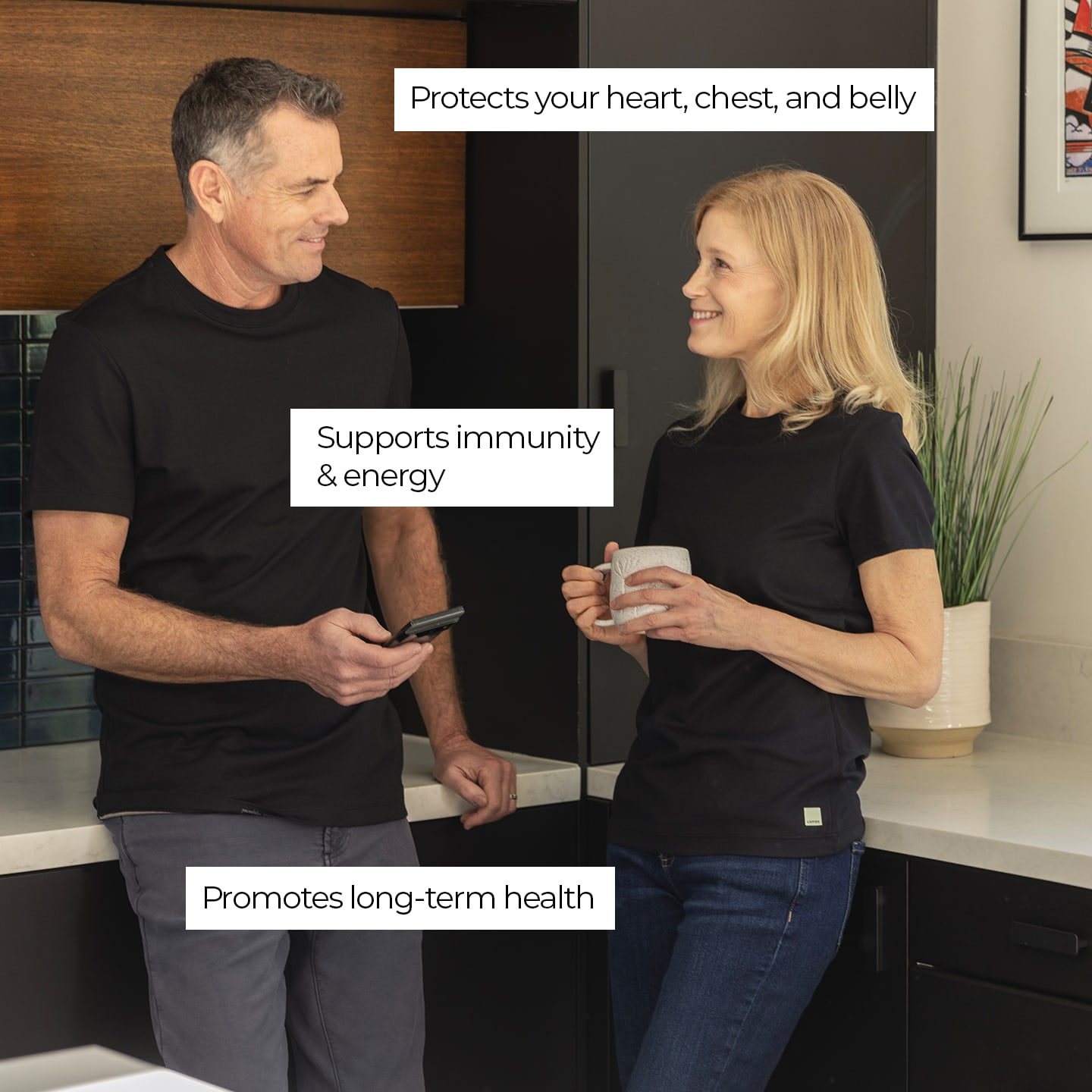 a man and a woman standing next to each other in a kitchen