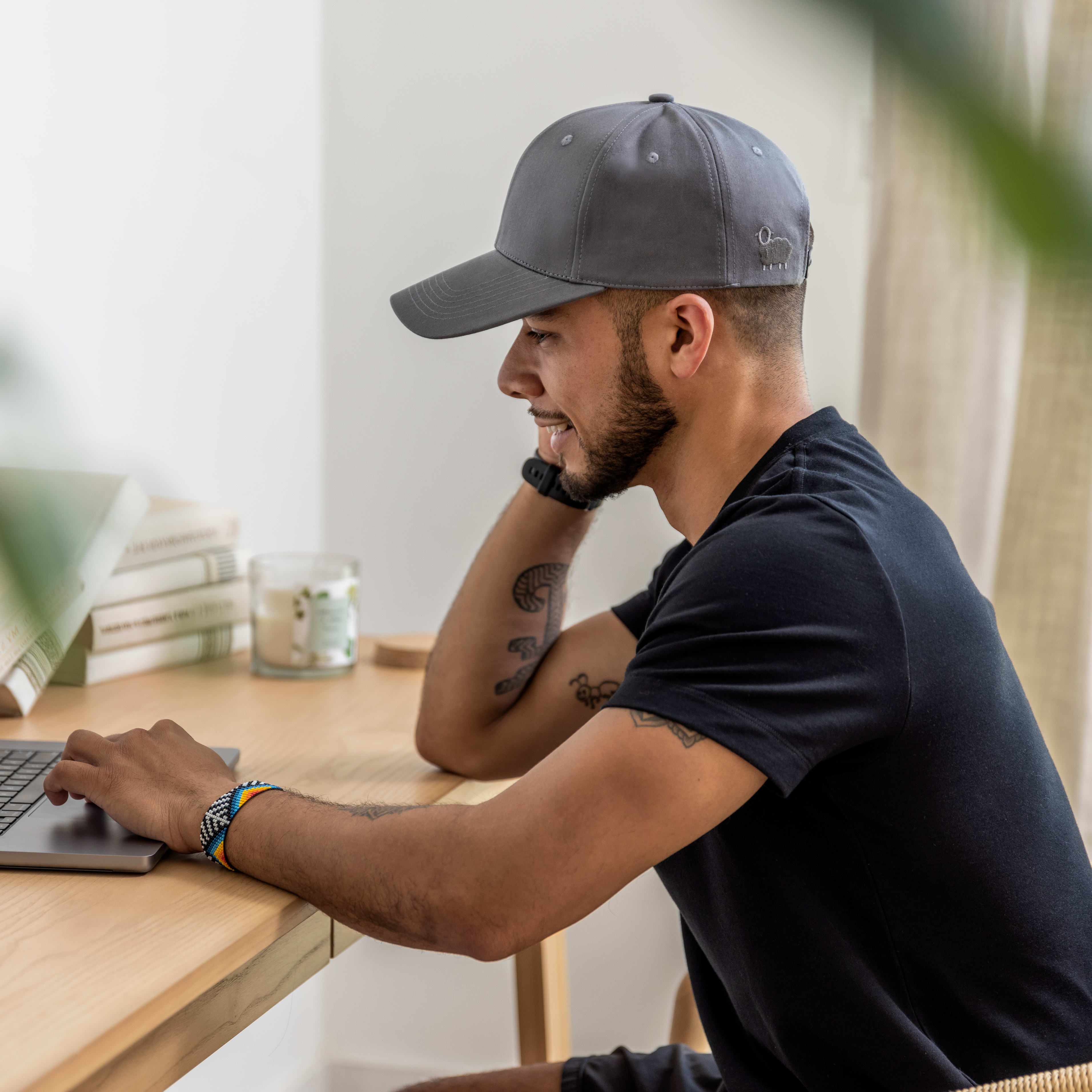 Man wearing the faraday cap and working at a desk.