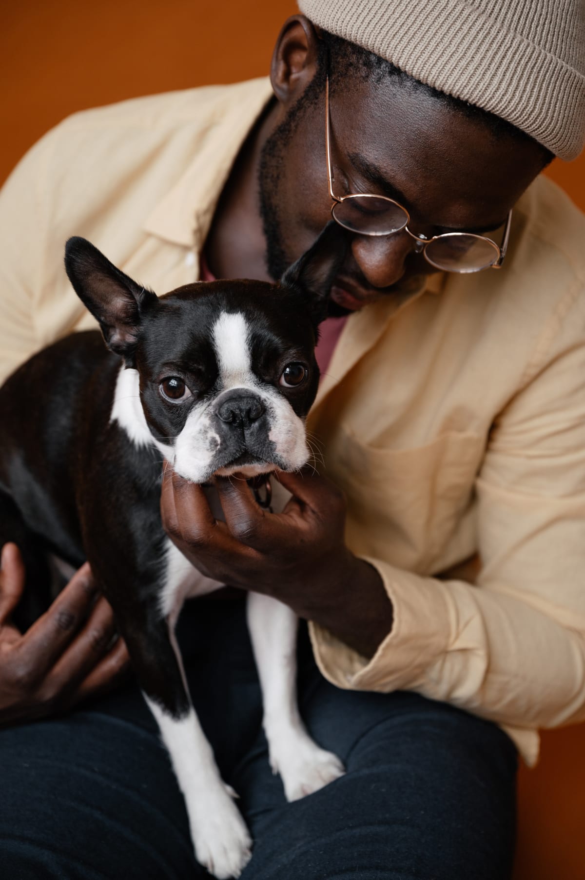 Man holding a Boston Terrier