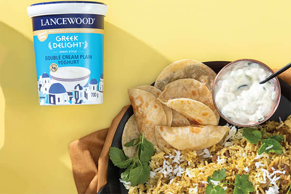 Easy breyani recipe with spiced lamb, rice and fresh coriander served with yoghurt and flatbreads