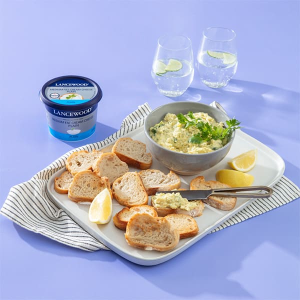 Snack platter ideas with Lancewood Pickled Fish Pâté, crusty bread, lemon wedges and fresh herbs.