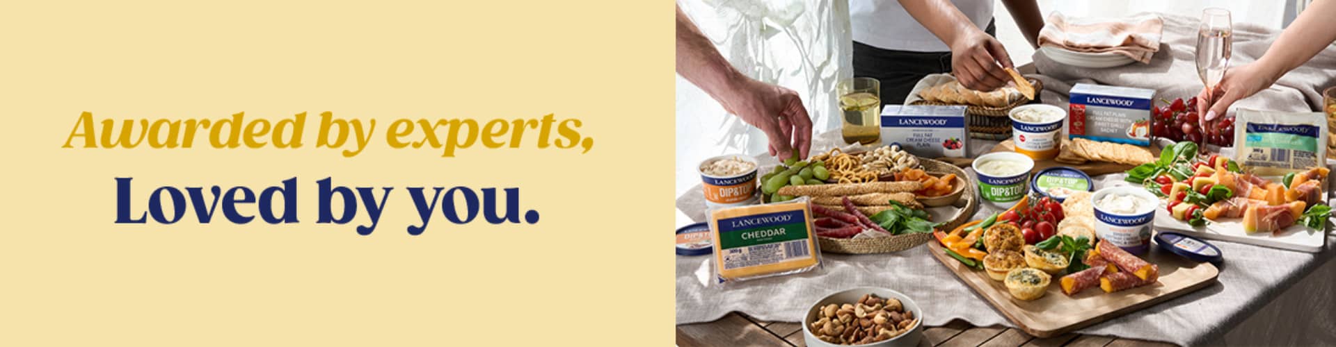 LANCEWOOD® award-winning cream cheese, cottage cheese and cheddar displayed on a shared grazing table, enjoyed by friends - celebrating products awarded by experts and loved by South Africans.