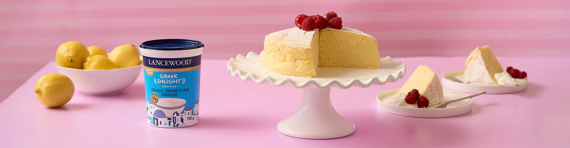 Light and airy lemon cloud cake made with Greek yoghurt, dusted with icing sugar and served with fresh raspberries