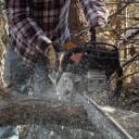 Ben Miles saws some larger logs during the volunteer workday.