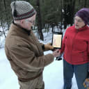 Two volunteer Stewardship Committee members conduct annual monitoring of an easement for Mahoosuc Land Trust.