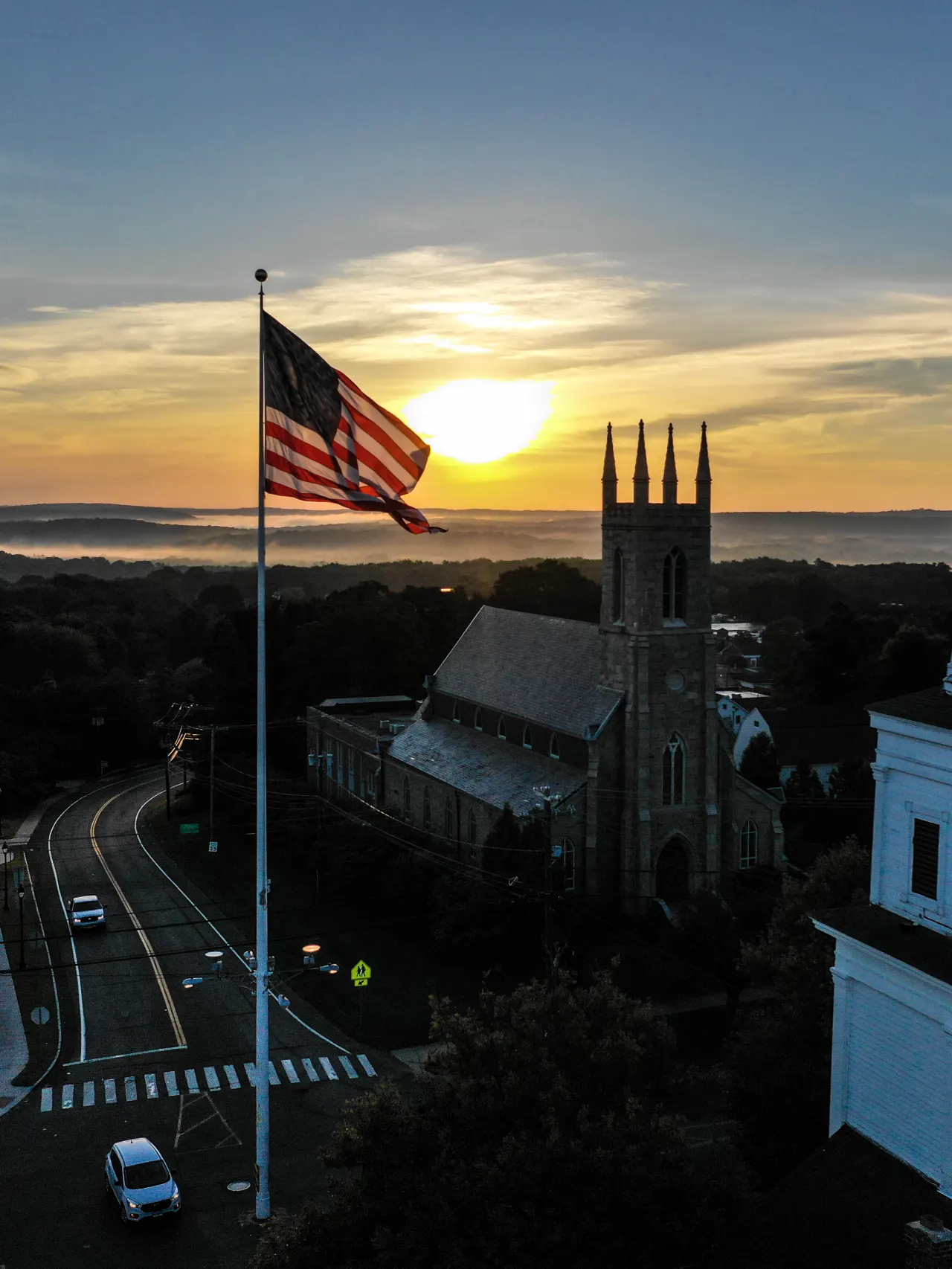 Photo of a town center with a flag in the middle.