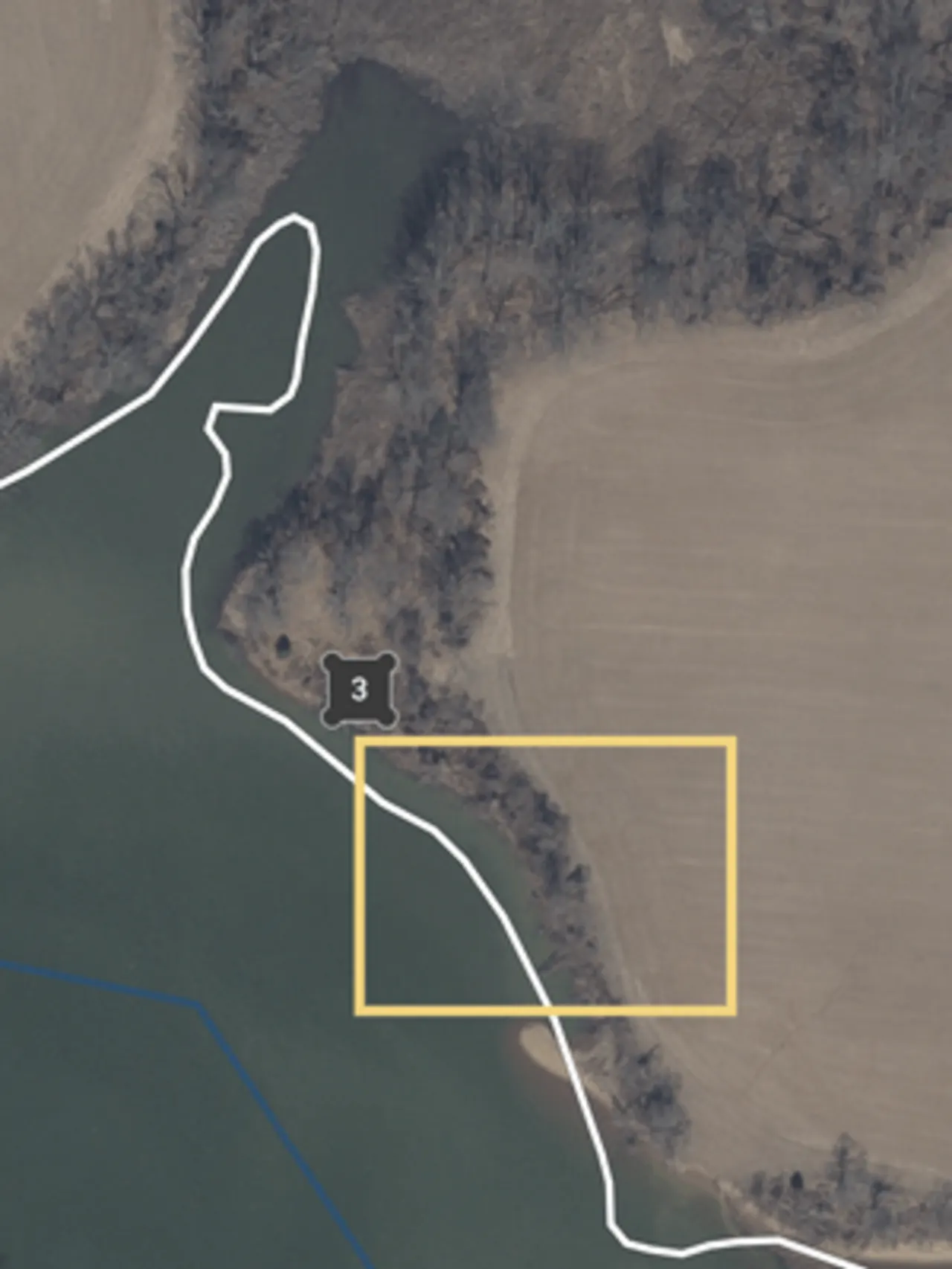 Photo from above of a farm, with a yellow box around one spot.