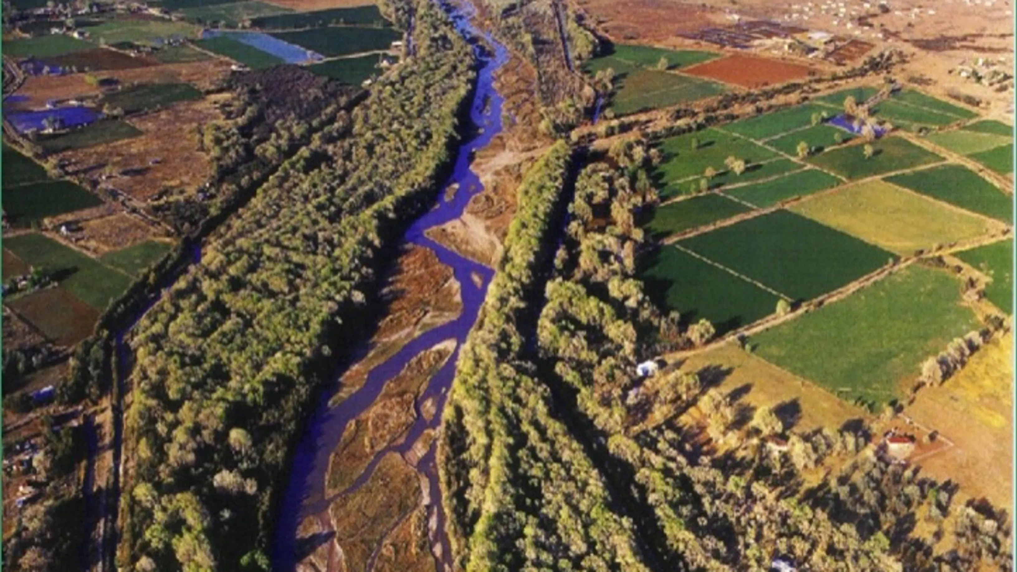 Photo from above of the Rio Grande surrounded by patches of farmland.