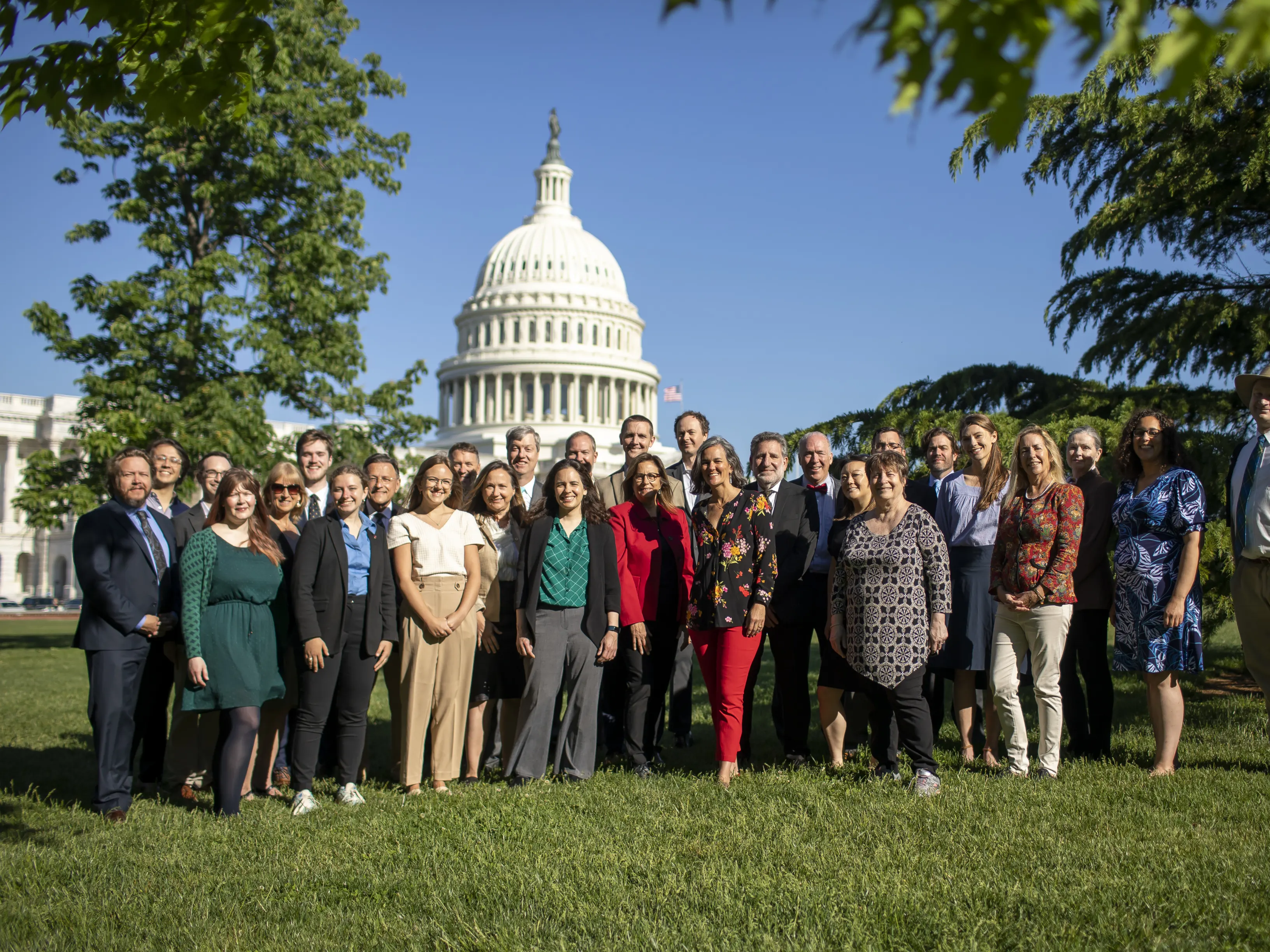 Group of 20-25 people standing in front of the U.S. Capitol
