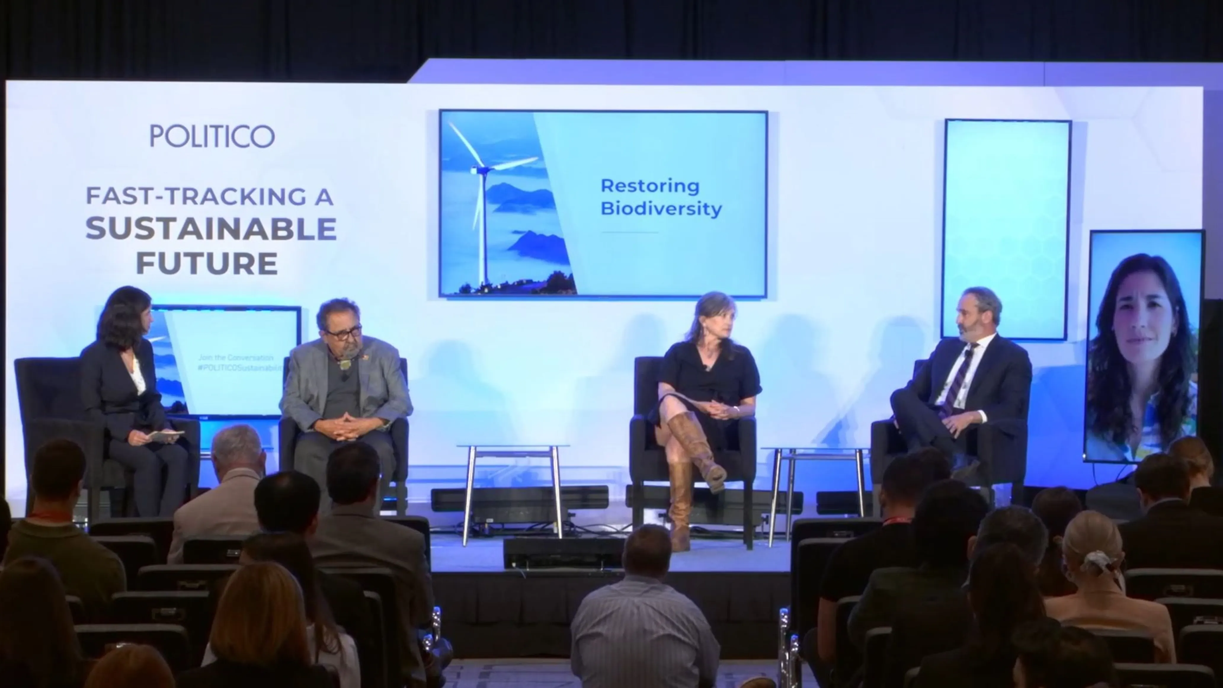 Four people, including Andrew Bowman, sit on stage for a panel on Restoring biodiversity