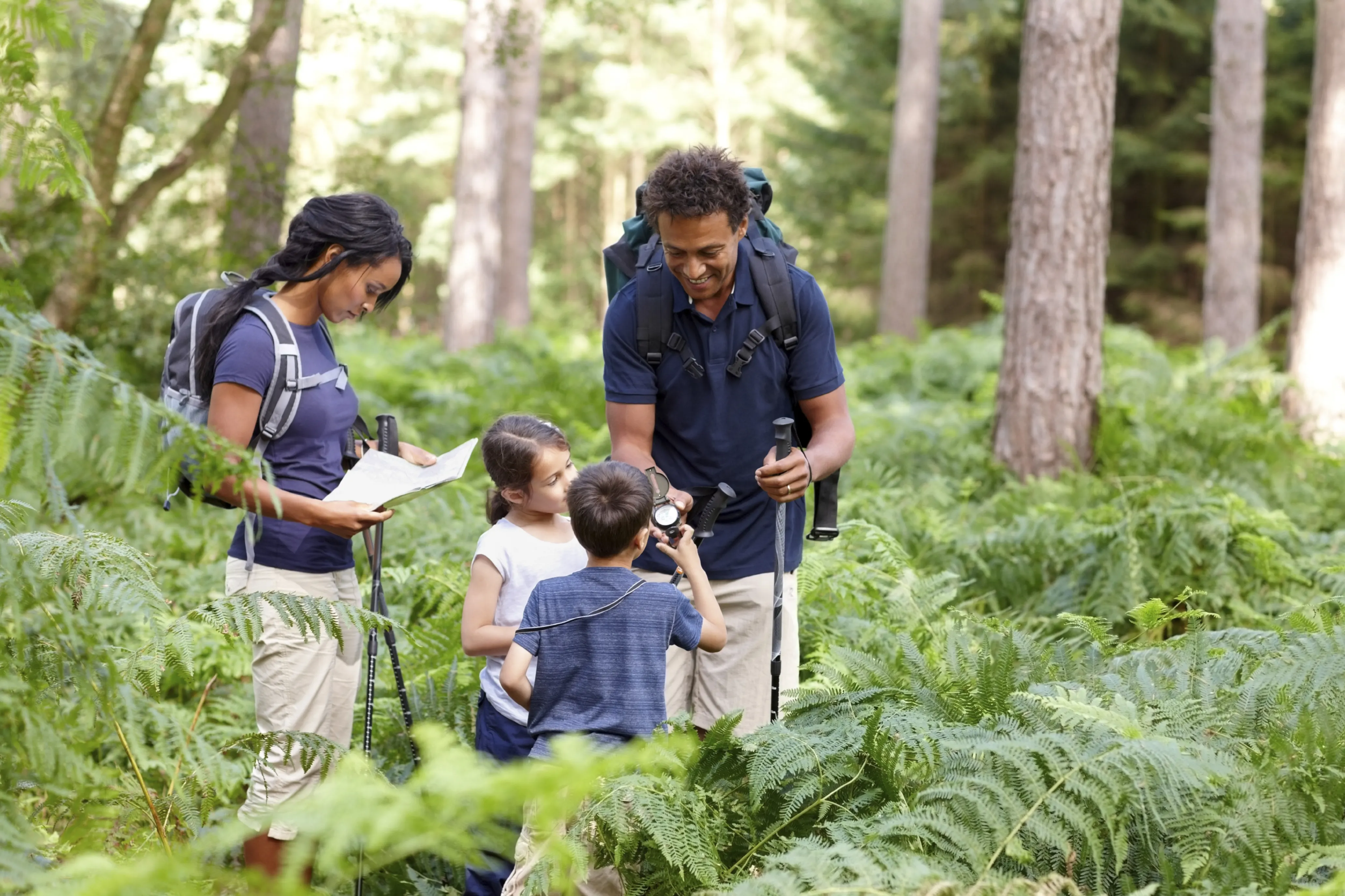 A family of four prepares for a hike