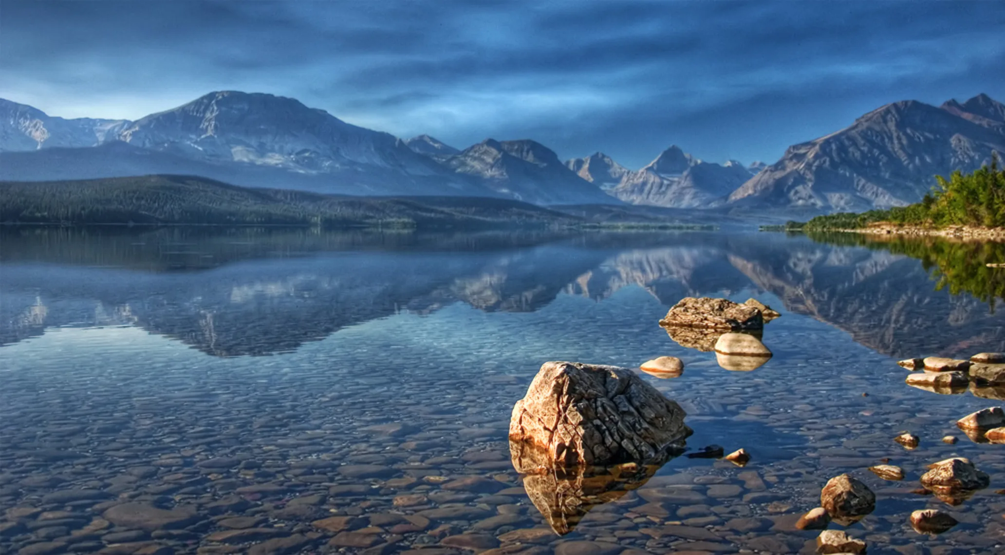 A clear lake with mountains in the background, Glacier National Park in Montana