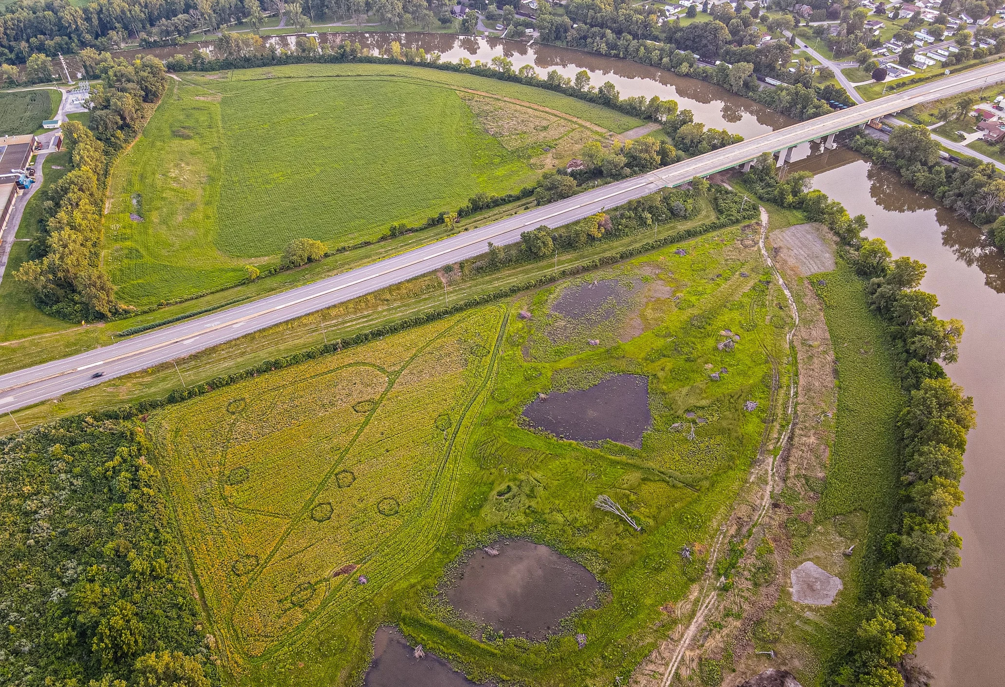 Aerial view of farmland next to a tributary running into Lake Erie.