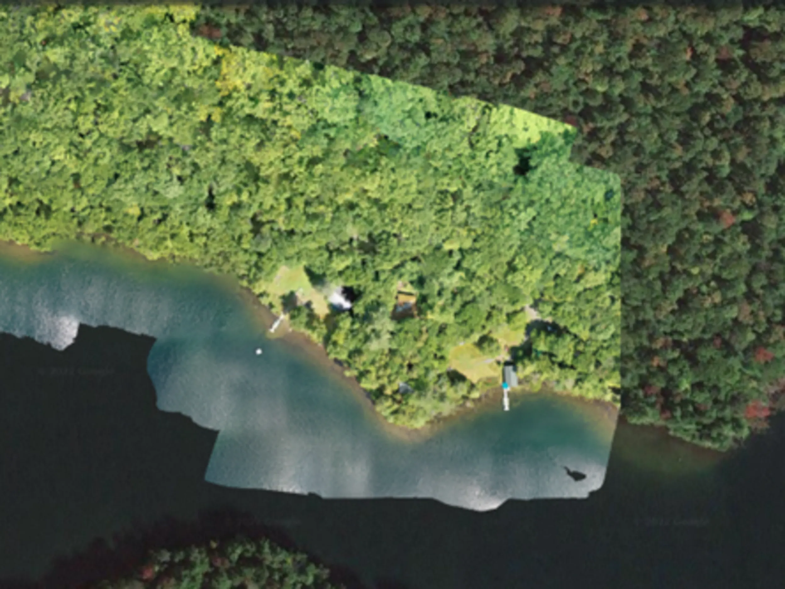 Aerial view of a creek bed that has been restored, surrounded by trees.