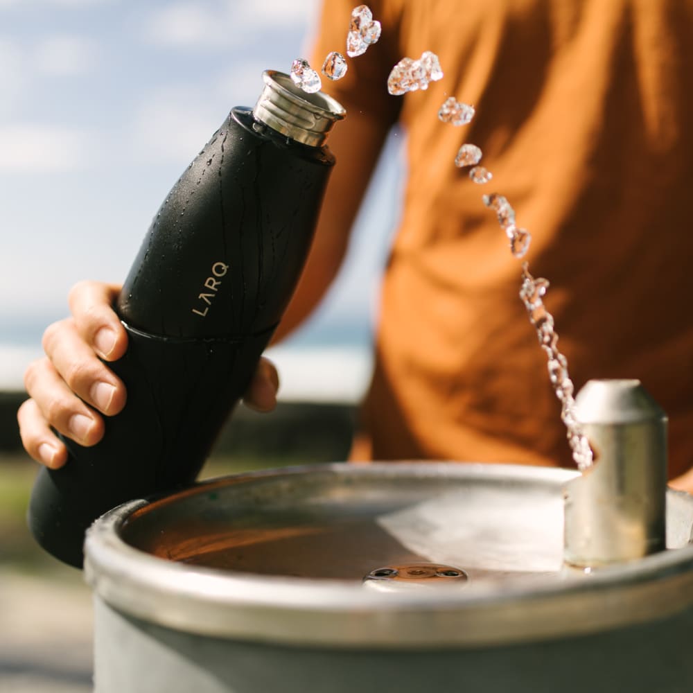 Larq purevis™ bottle being filled with water