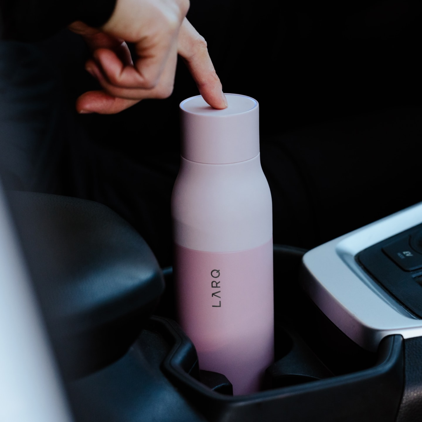 Finger pressing a button on LARQ Bottle PureVis