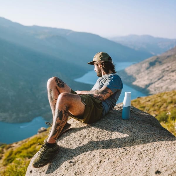 Photo of Larq Bottle PureVis™ - White / Marine with a man on a viewpoint