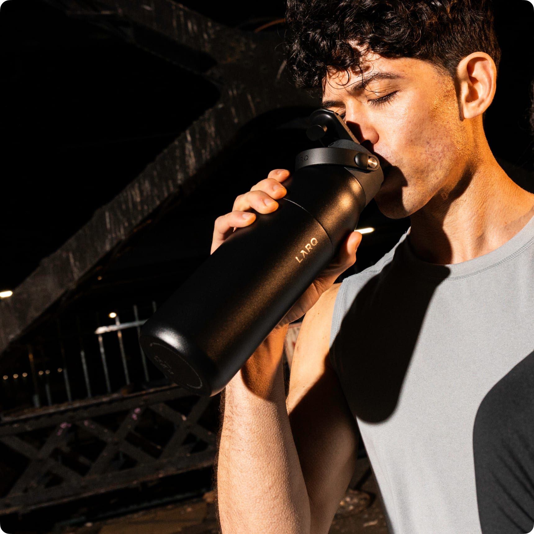 Man drinking water from Larq Purevis 2 bottle