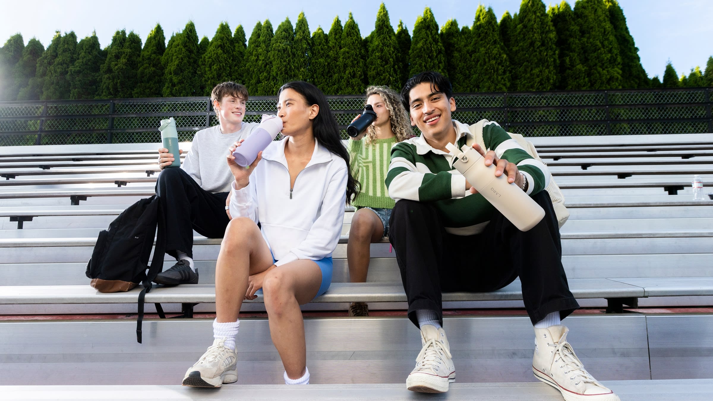 Students holding LARQ bottles