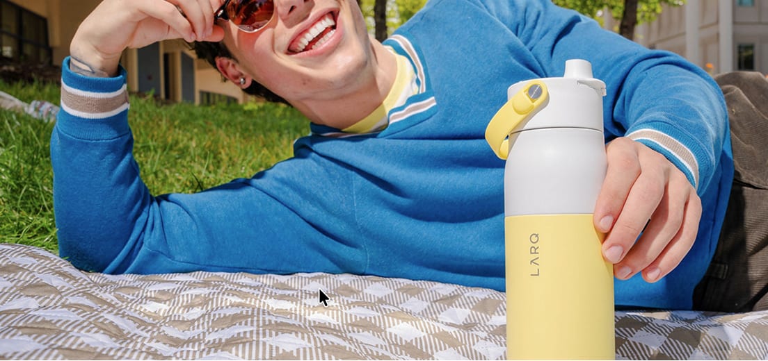 Person holding a cūva flavor pod compatible bottle
