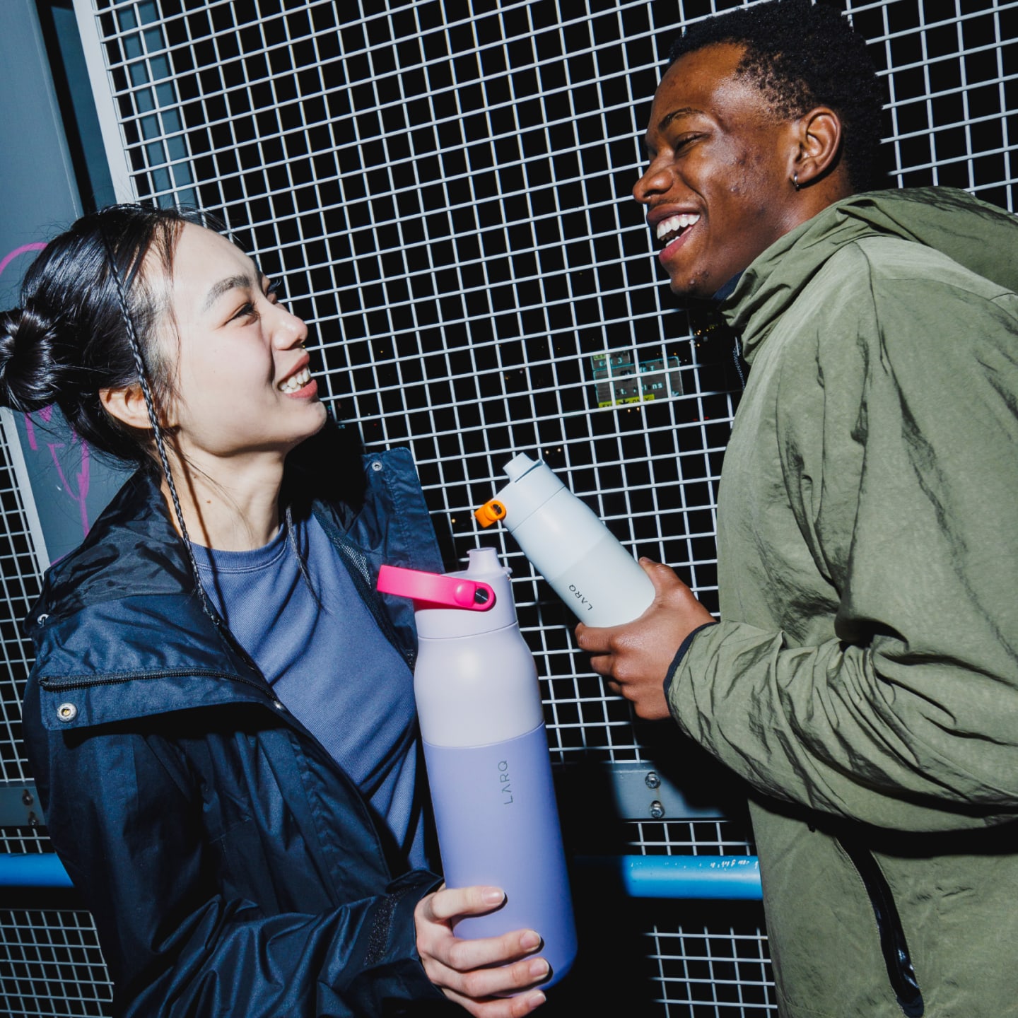 People holding LARQ Bottle PureVis 2 bottles with colored LARQ Bottle Handles